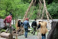 【写真】蔓の門をくぐる参加者や登山者